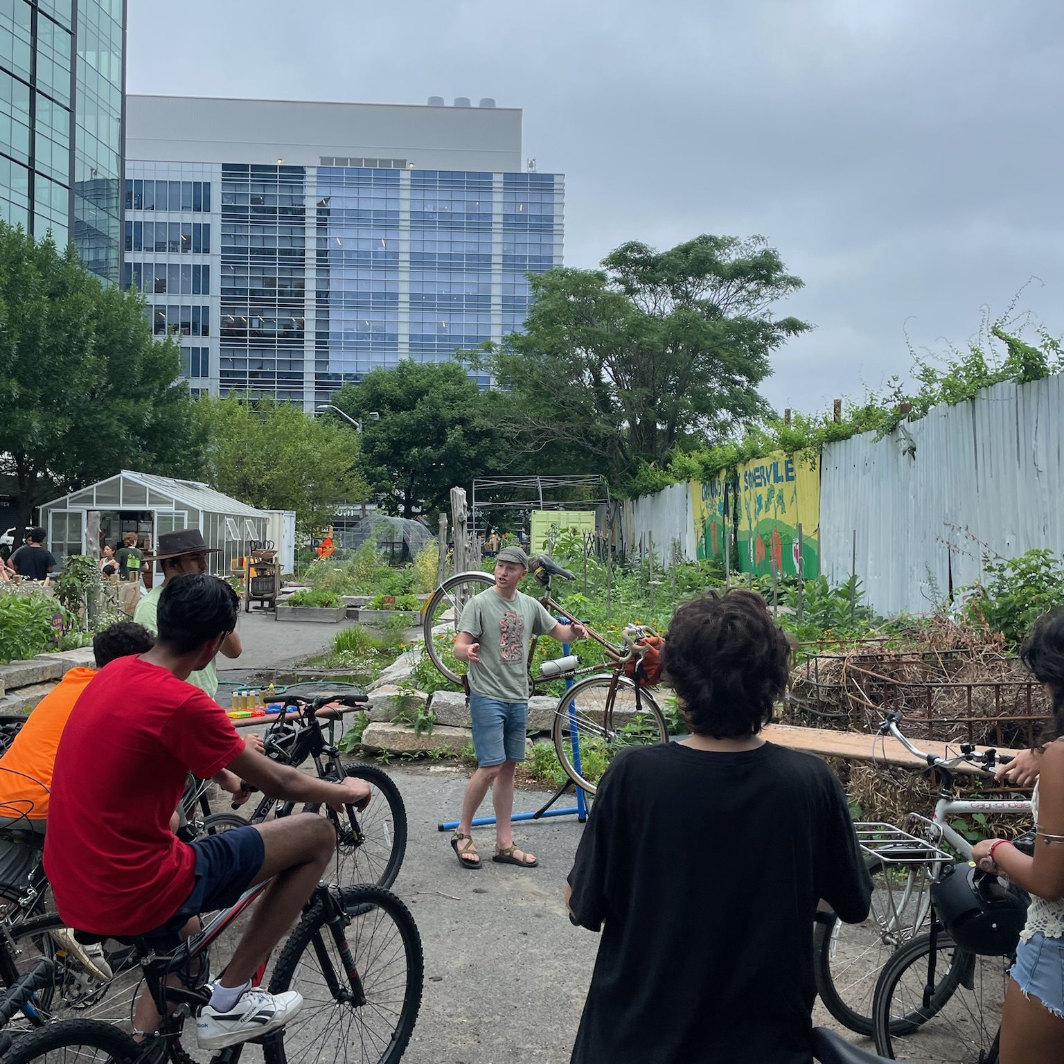 Staff member Paul from the Somerville Bike Kitchen teaches the Green Team bike maintenance for their summer rides.